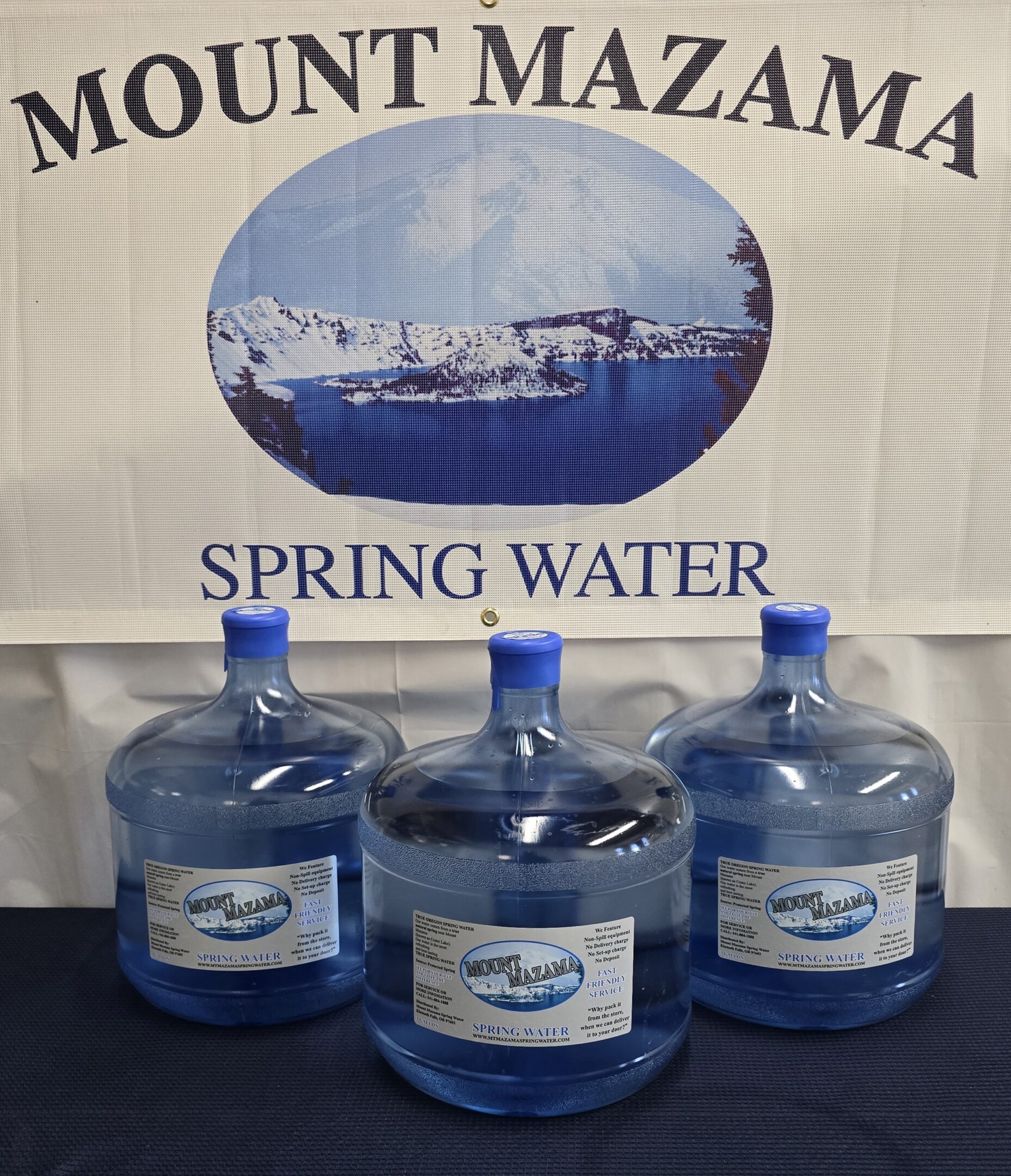 Three large water containers labeled Mount Mazama spring water.