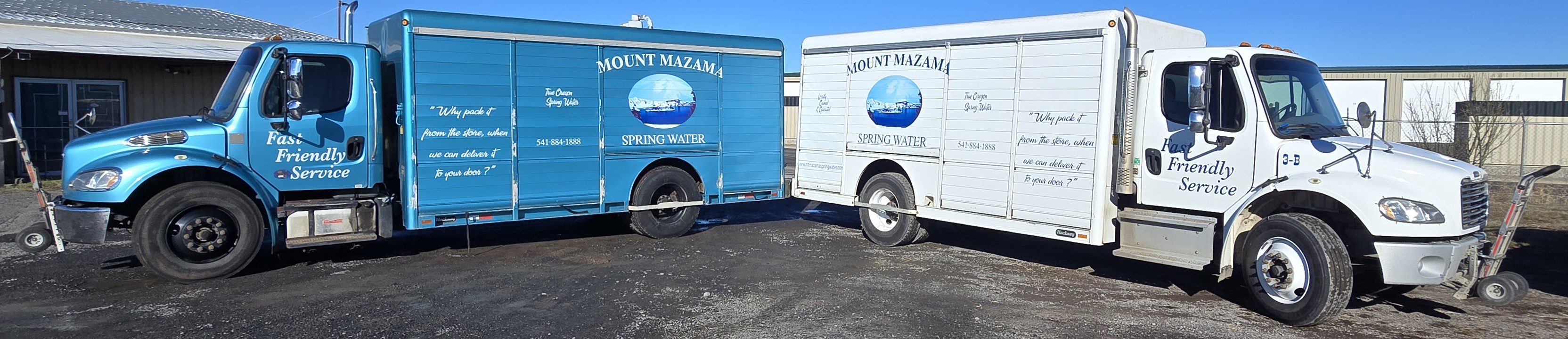 Two Mount Mazama spring water trucks parked side by side.